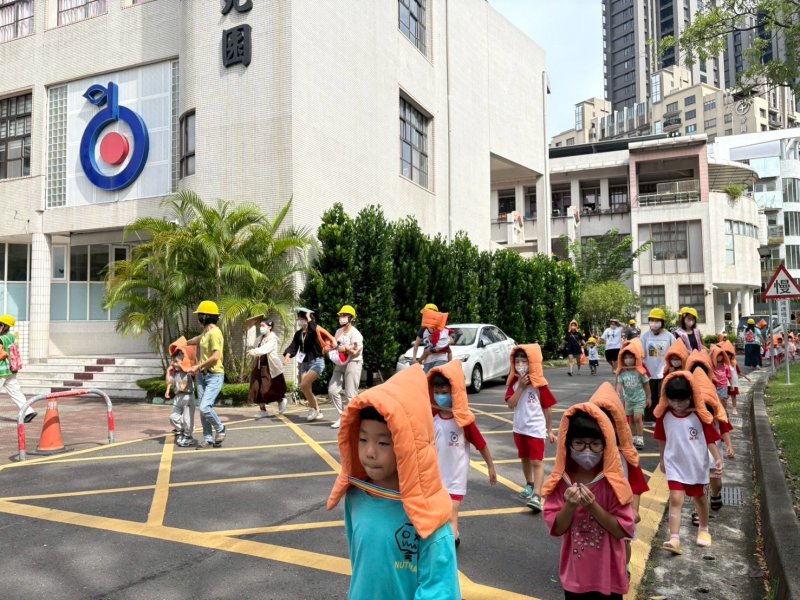 幼兒戴上教育局補助購買的防護頭套，井然有序的隨老師進行避難。（裕誠幼兒園提供）