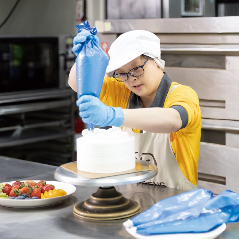  憨兒正在庇護工場努力工作，從備料、烘焙到裝飾，每一道工序都不馬虎。