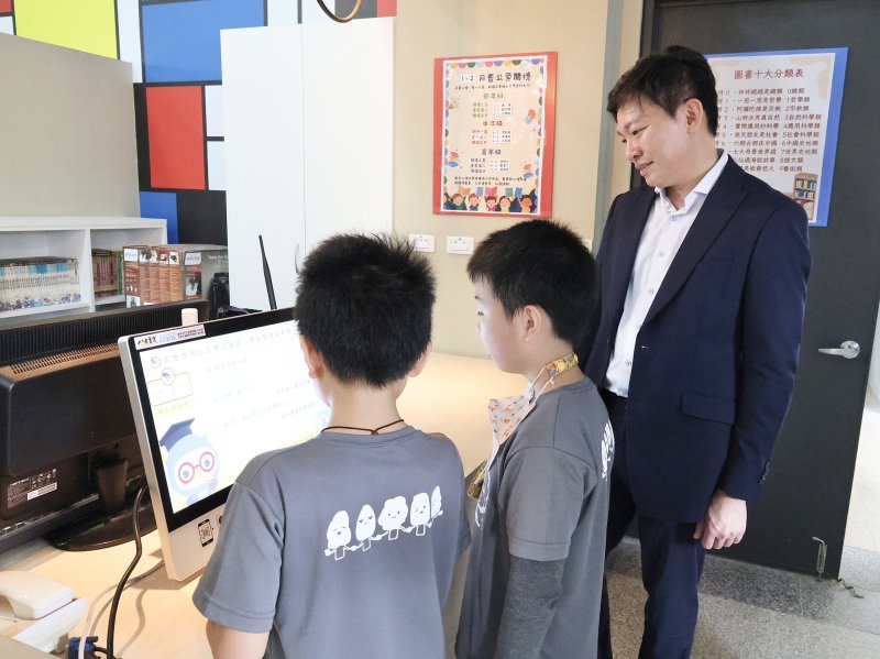 教育局長吳立森在曹公國小共站讀與學童共讀繪本，了解共讀站建置「AI智慧系統」。